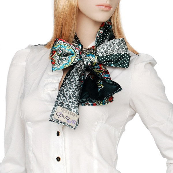 Silk scarf in teal and dark green with paisley prints, knotted at collar