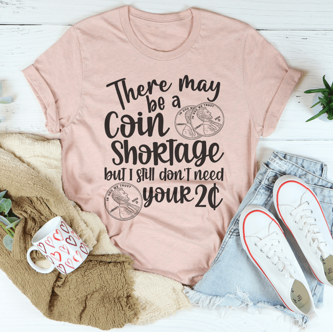 Peach T-shirt with centered "Coin Shortage" graphic and coin icon print
