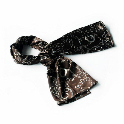 Black silk scarf with circular chain and padlock print, neatly tied at the neck