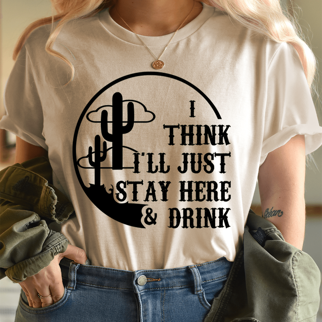 Tan T-shirt with black cactus graphic: I THINK I'LL JUST STAY HERE & DRINK