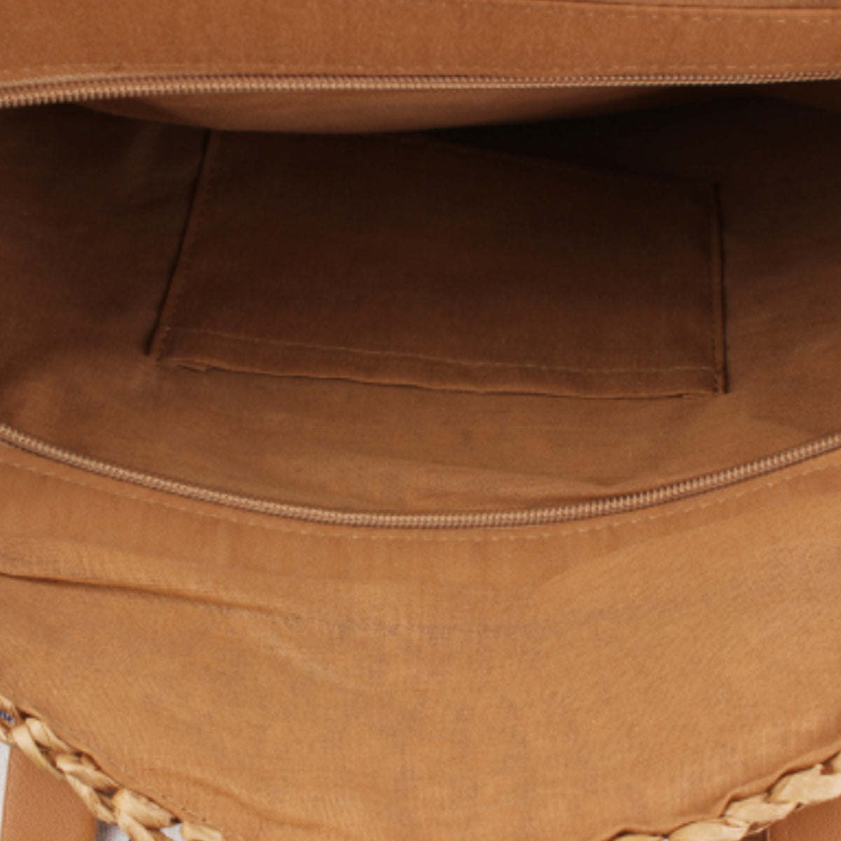 Tote bag interior compartment with brown fabric lining and stitched seams