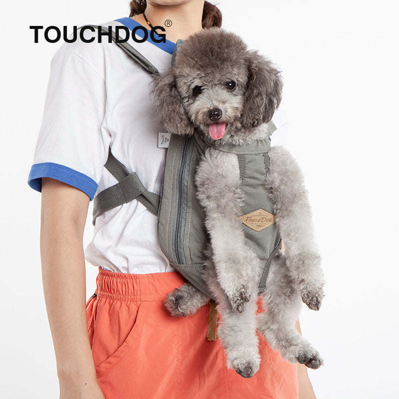 Dog carrier backpack with gray front panel and mesh openings, dog being carried