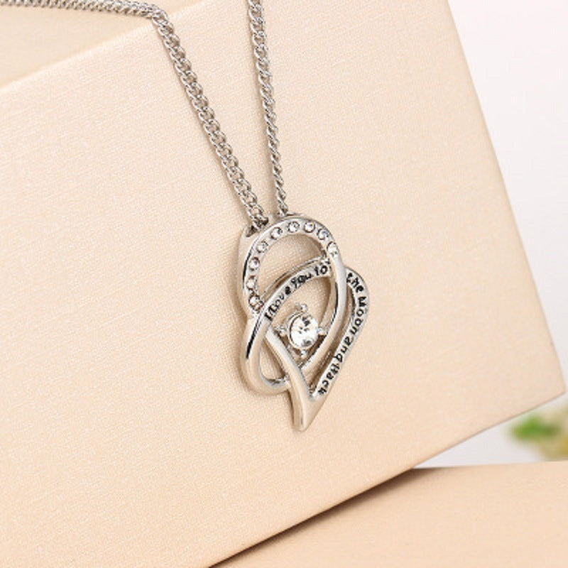 Sterling silver heart pendant necklace with cubic zirconia center stone and heart loop detail