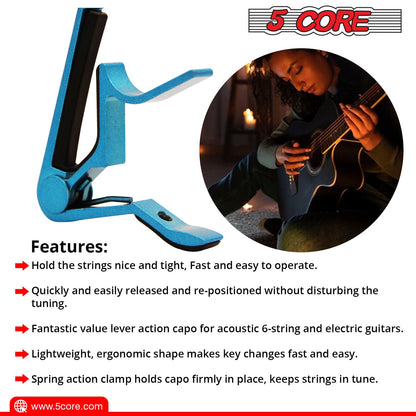 Blue guitar capo clip with black clamping bar and spring lever, with guitar nearby.