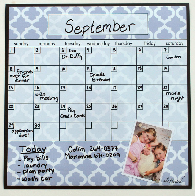 Lattice dry-erase fridge calendar with September grid and handwritten notes, photo magnet