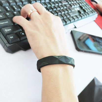 Anti-static bracelet on wrist in dark black silicone with adjustable hole section