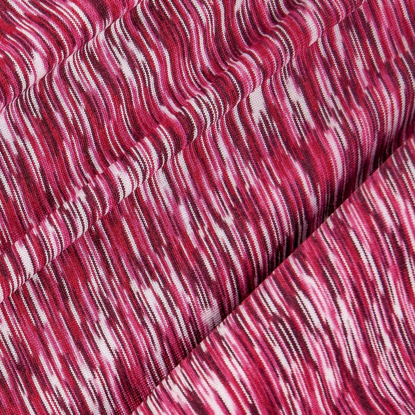 Close-up of maroon heathered performance fabric with wavy texture and stitched seam