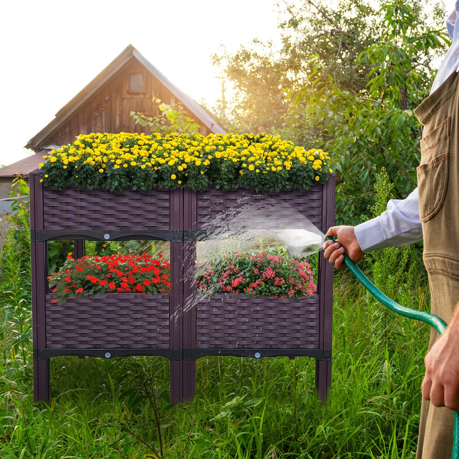 Dark purple raised garden bed planter with four compartments and legs, misting water over plants
