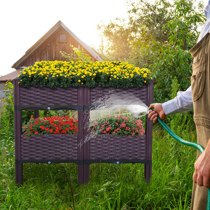 Dark purple raised garden bed planter with four compartments and legs, misting water over plants