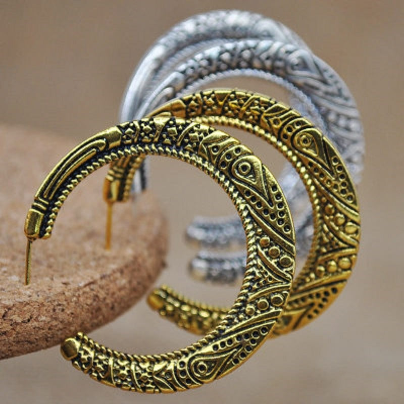 Gold-tone stud hoop earrings with ornate engraved crescent dome and beaded border