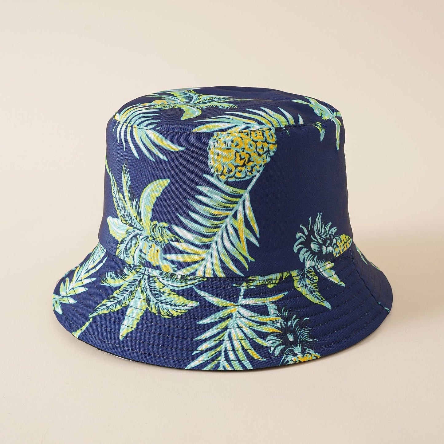 Navy fisherman hat with green and yellow pineapple and palm-leaf tropical print
