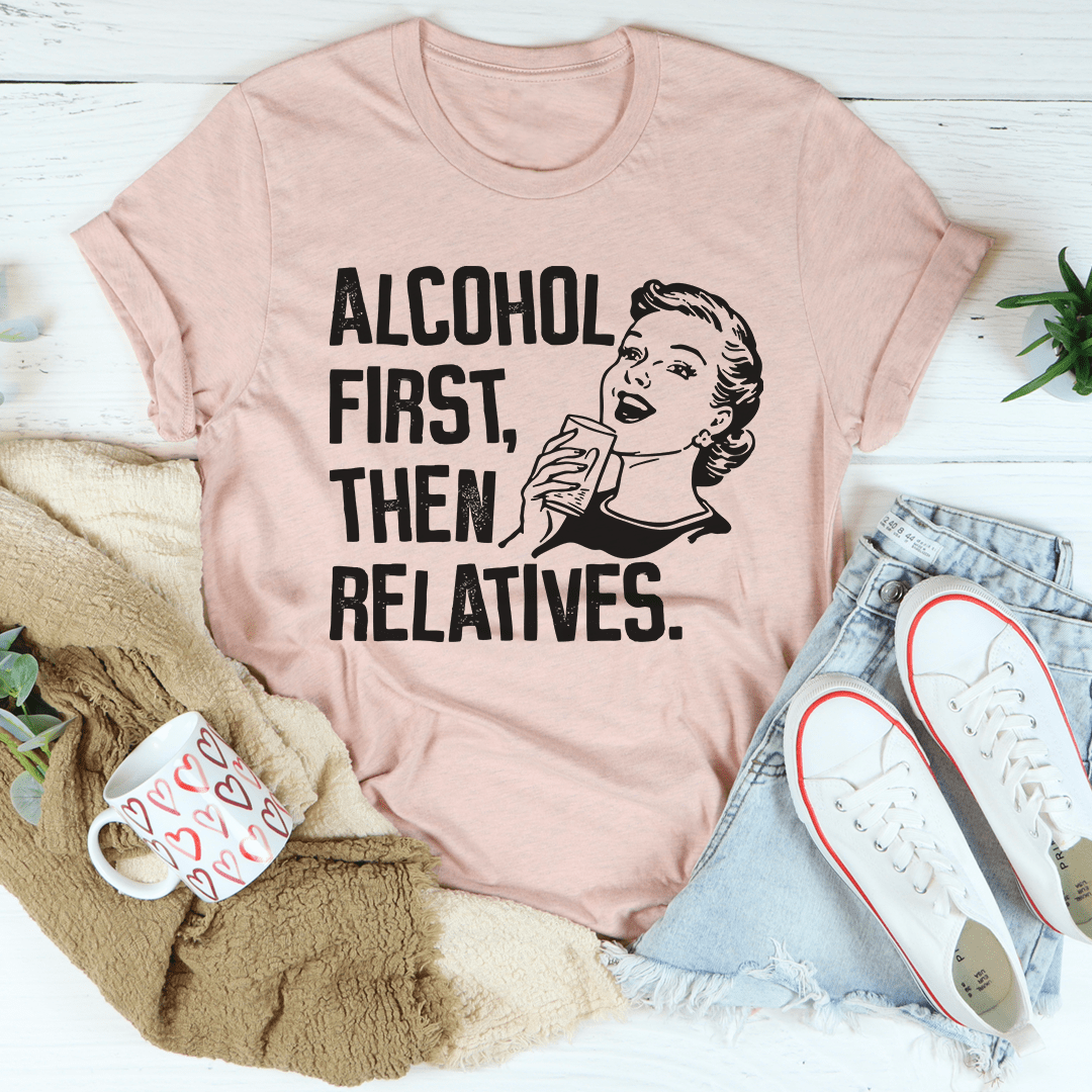 Peach T-shirt with black “ALCOHOL FIRST, THEN RELATIVES.” graphic
