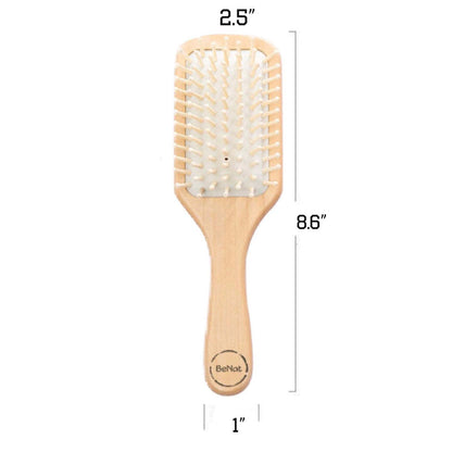 Natural wooden detangling hair brush, top-down view of white bristle pad
