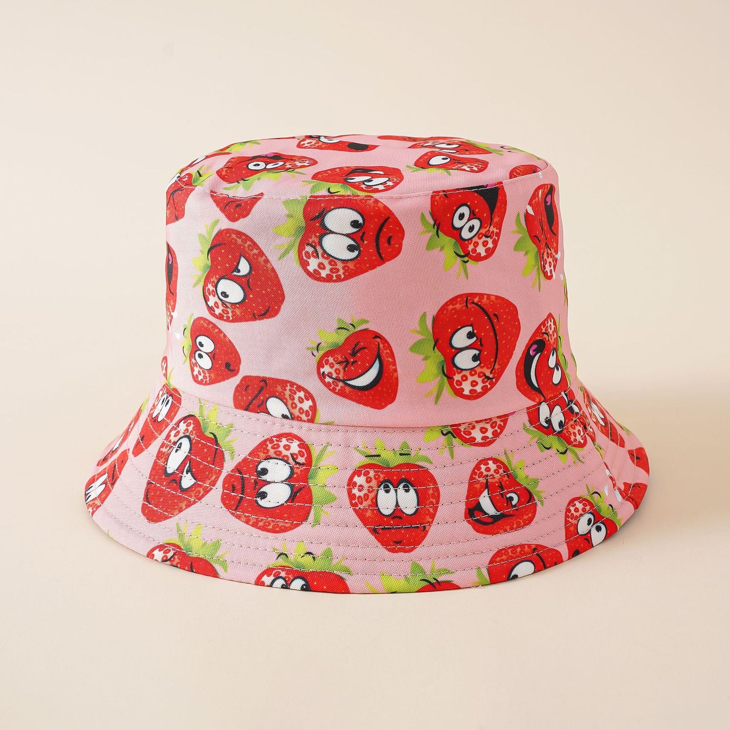 Pink cartoon strawberry bucket hat, wide brim, all-over face print
