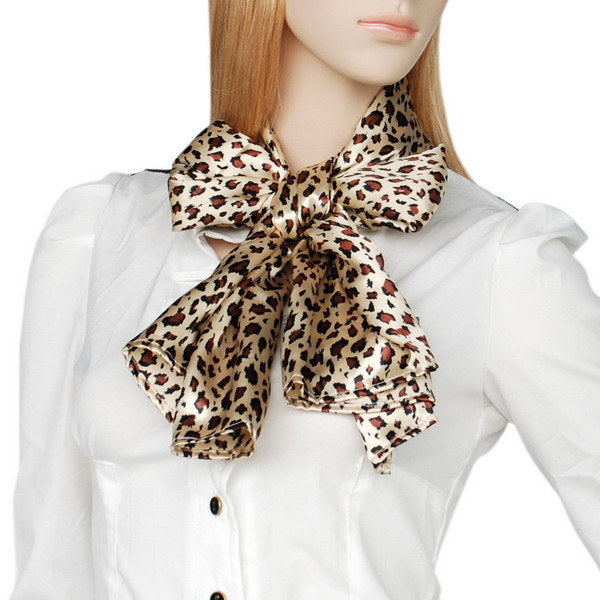 Brown and cream leopard print scarf with bow-like knot at neck