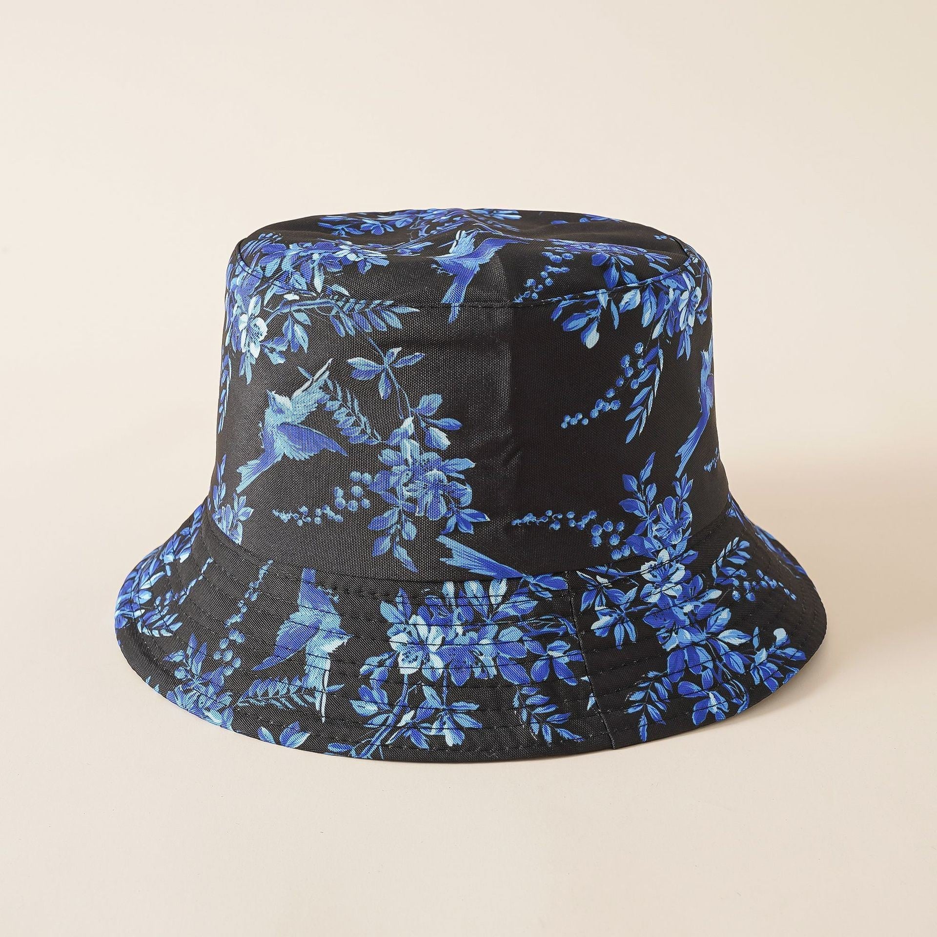 Fisherman hat in black with blue floral and bird pattern, wide brim