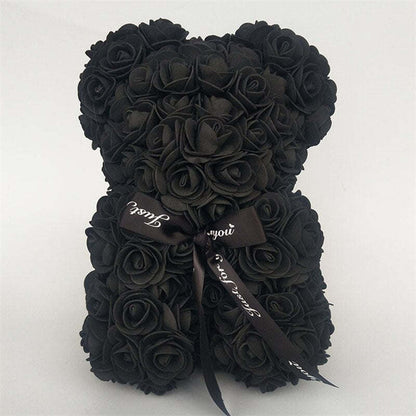 Black rose teddy bear with black bow ribbon tied at the neck