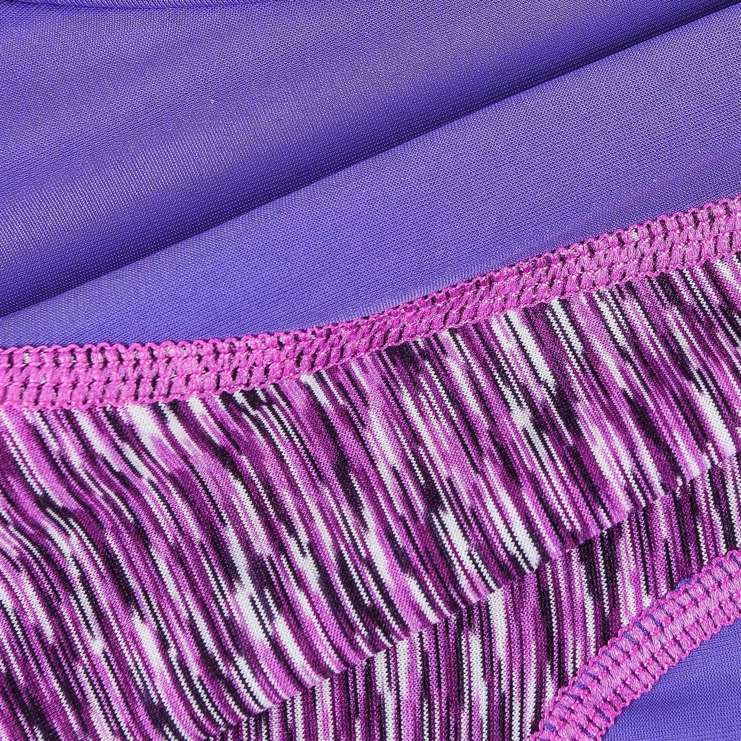 Close-up of purple heather fabric with pink elastic trim and stitched seam