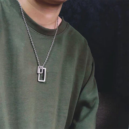 Silver geometric double-rectangle pendant necklace worn on a chain