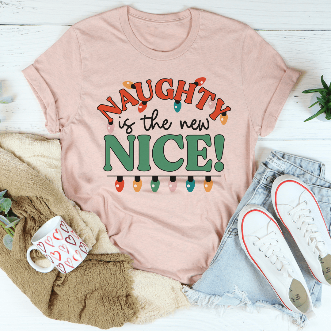 Peach crewneck T-shirt with large 'Naughty is the new NICE!' lettering graphic