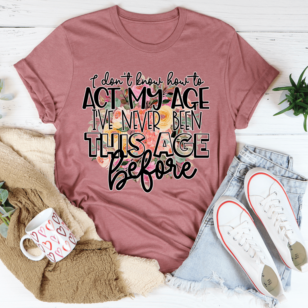 Mauve crewneck graphic T-shirt with 'act my age' slogan in bold script