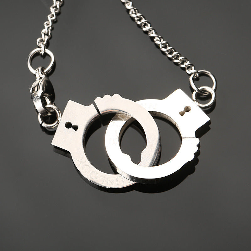 Stainless steel handcuff pendant necklace with two handcuff charms, chain detail