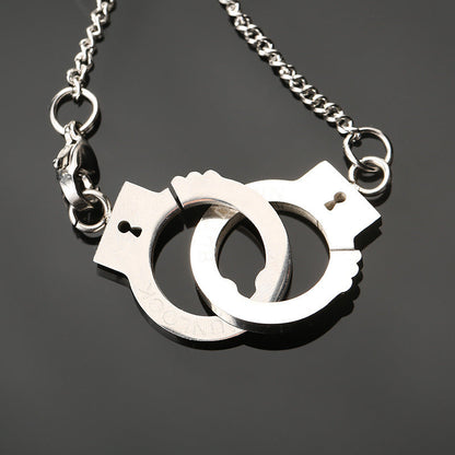 Stainless steel handcuff pendant necklace with two handcuff charms, chain detail