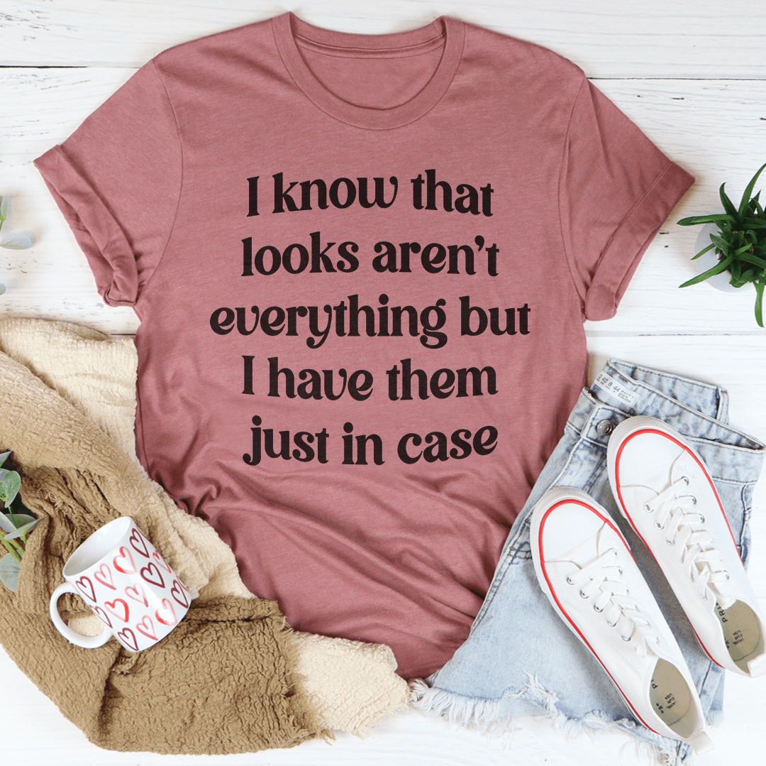 Mauve crewneck T-shirt with large dark quote text: I know that looks aren't...