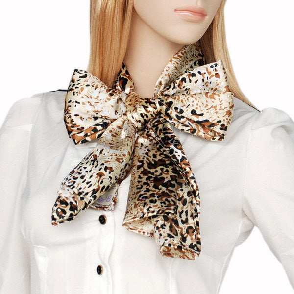 Silk scarf with bow-tie knot, gold and brown leopard pattern on cream base