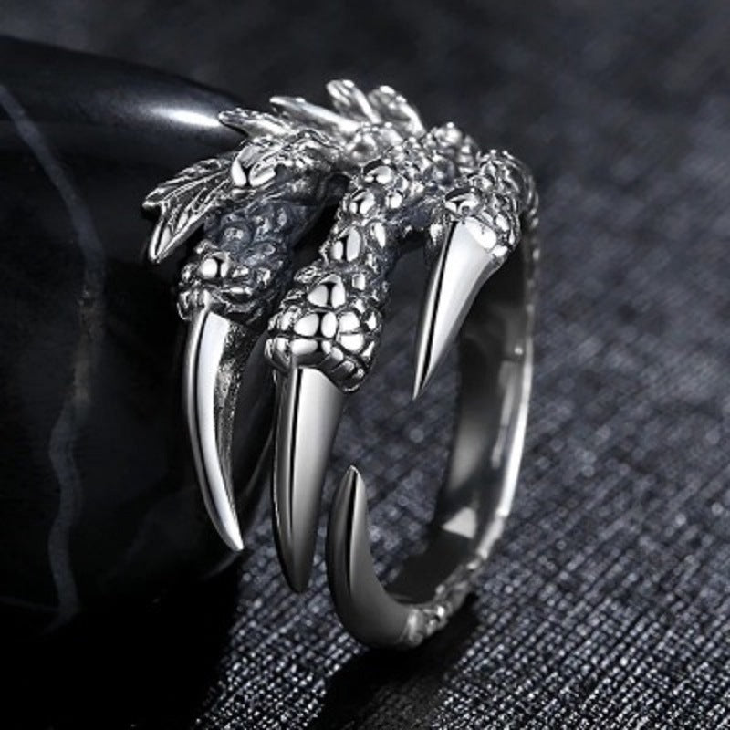 Silver open claw ring featuring dragon head and long claw points, wide open band