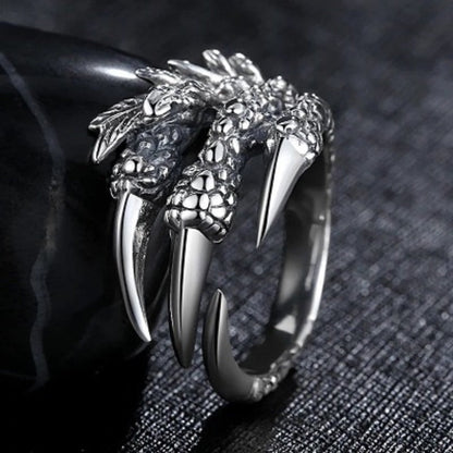 Silver open claw ring featuring dragon head and long claw points, wide open band