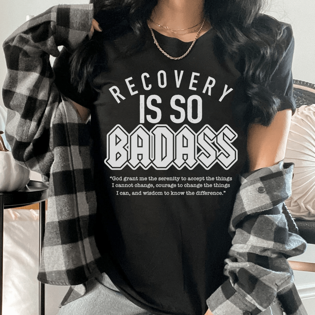 Black crew-neck T-shirt featuring “RECOVERY IS SO BADASS” front graphic