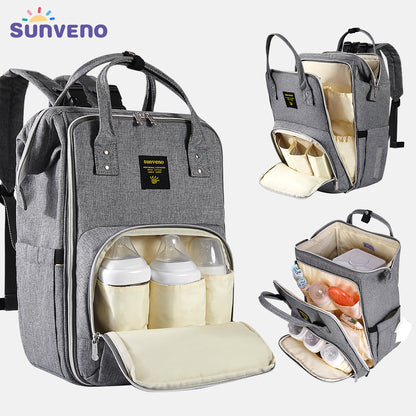 Gray diaper bag backpack with organized front pocket and matching changing-pad insert