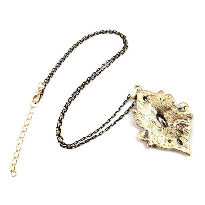 Gold-tone necklace chain with cat-head pendant, framed in clear stones