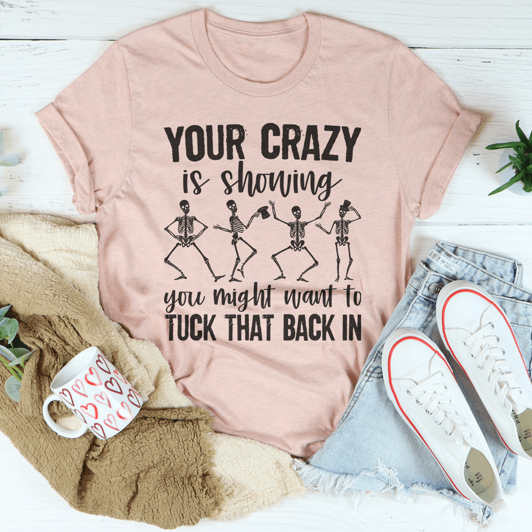 Light pink graphic crewneck T-shirt with skeleton dancers and “TUCK THAT BACK IN”.