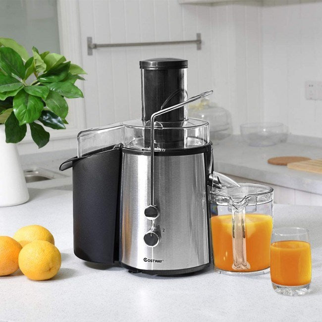 Stainless electric centrifugal juice extractor with black pulp bin and clear juice glasses