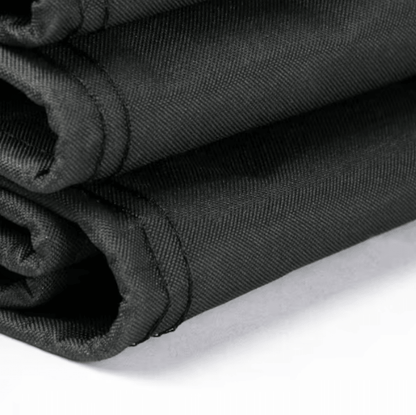 Rolled black fabric fire pit cover with stitched edge and drawstring channel