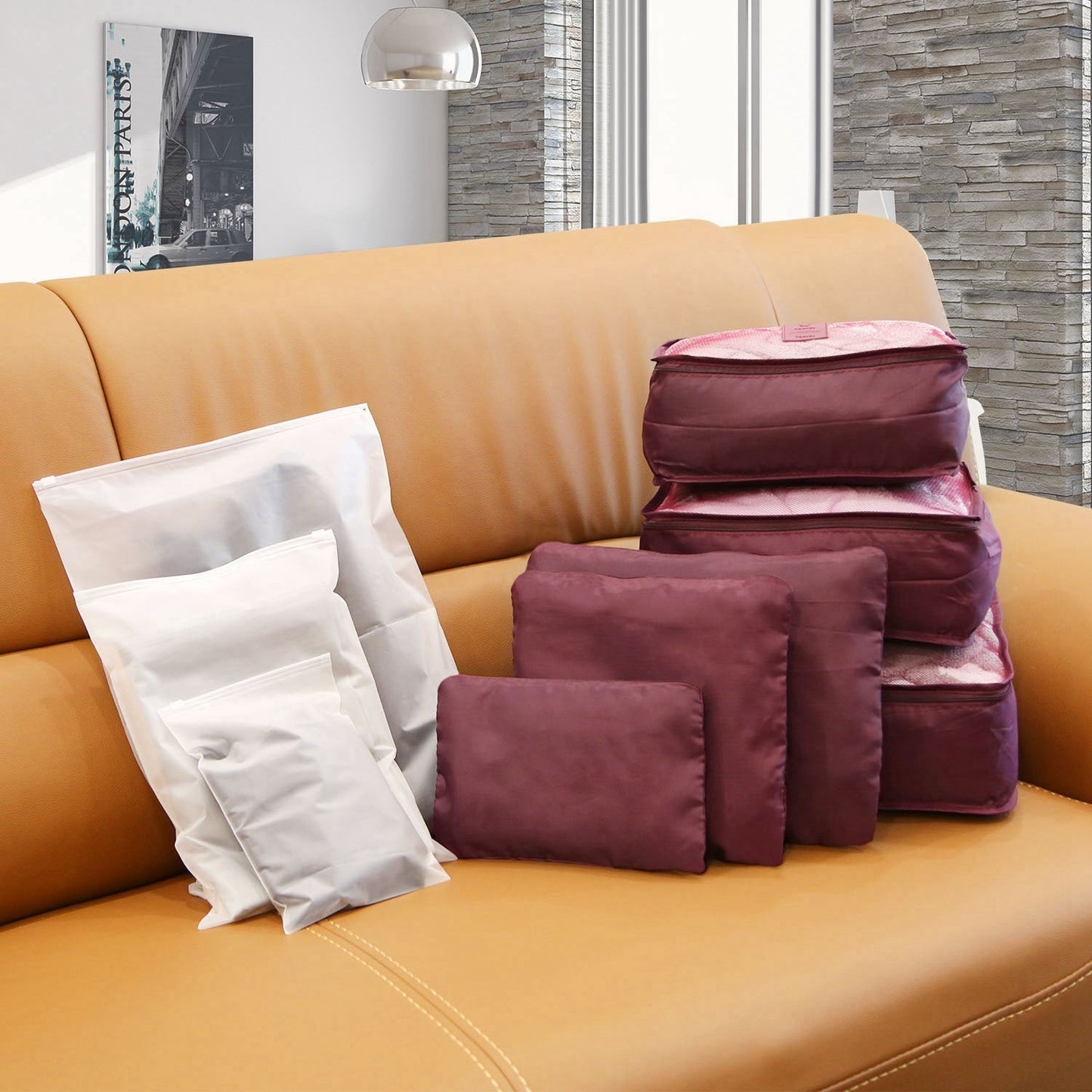 Water-resistant packing cube set with burgundy cubes and one white storage bag, zippered.
