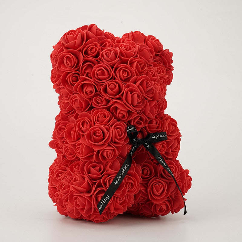Red rose teddy bear with dense rosette texture and black ribbon bow