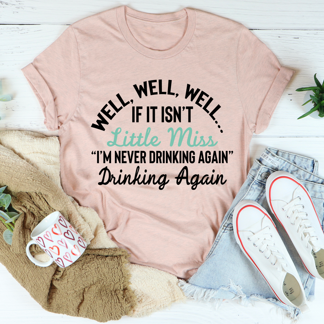 Dusty pink T-shirt with 'Well, well, well' headline and 'I'm never drinking again' text