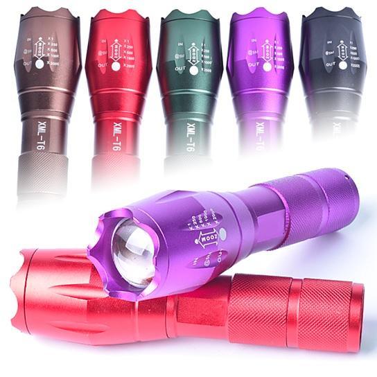 Zoomable focusing flashlight lineup with purple flashlight in front and red flashlight below.