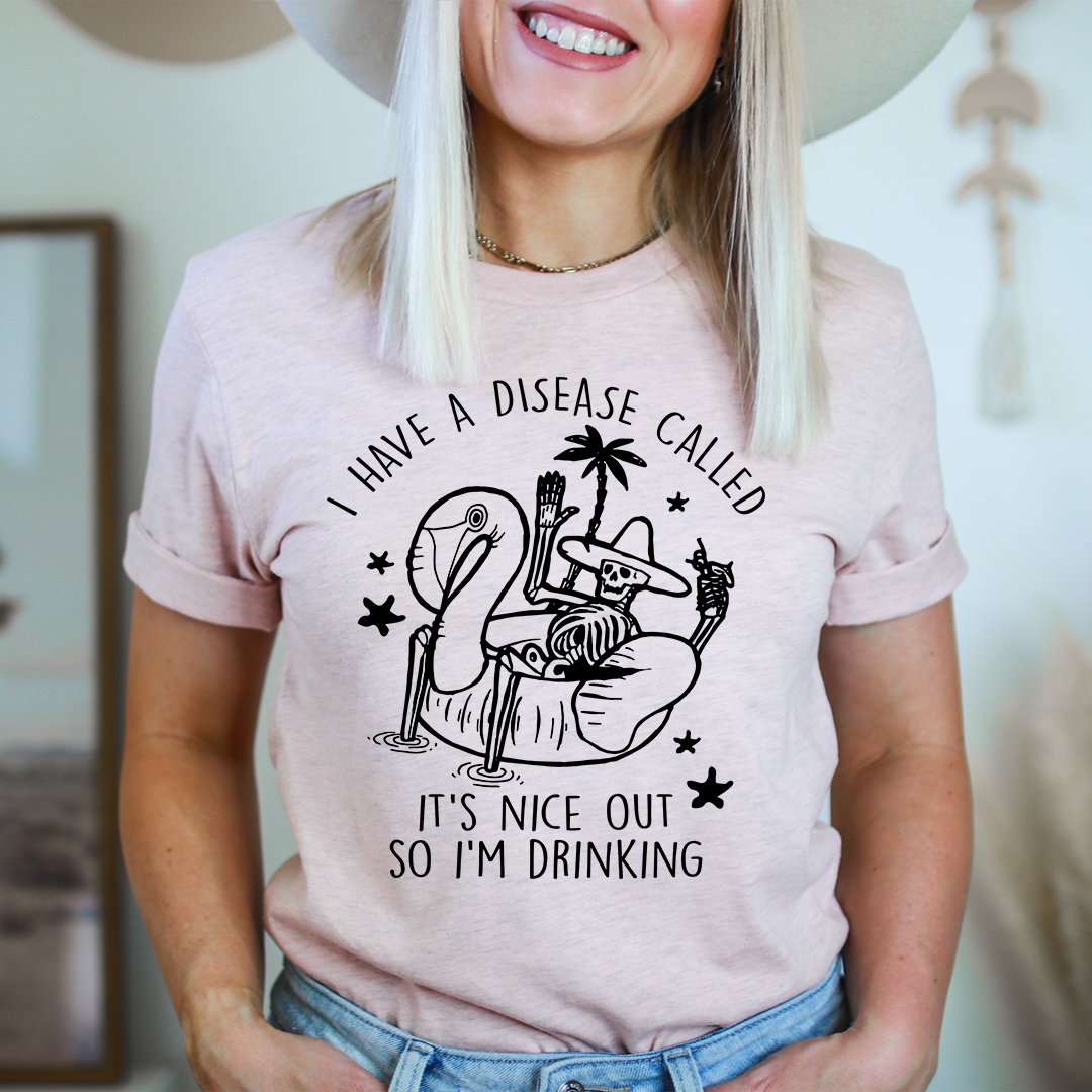 Light pink crew-neck T-shirt with cactus drink graphic and 'It's nice out' lettering.