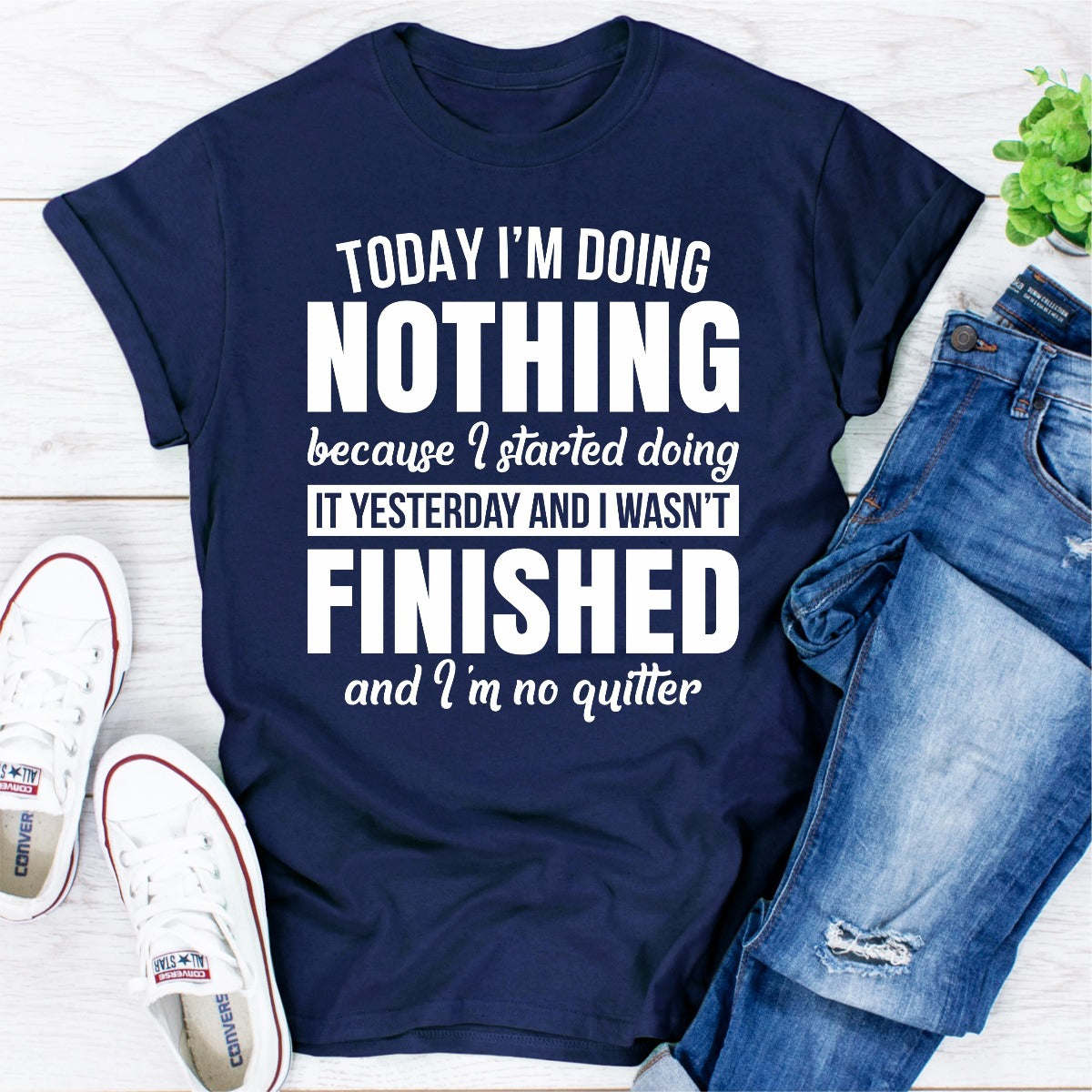 Navy T-shirt with “NOTHING FINISHED” humorous quote graphic