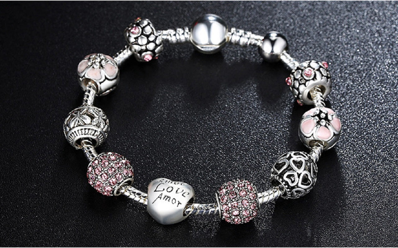 Silver-tone charm bracelet with heart, flower, and crystal bead charms