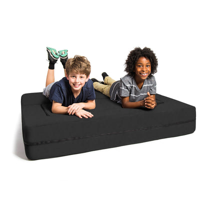 Black microsuede modular ottoman with cushioned top, two kids sitting