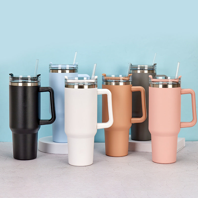 Assorted pastel insulated travel tumblers with handles, clear lids, and drinking straws