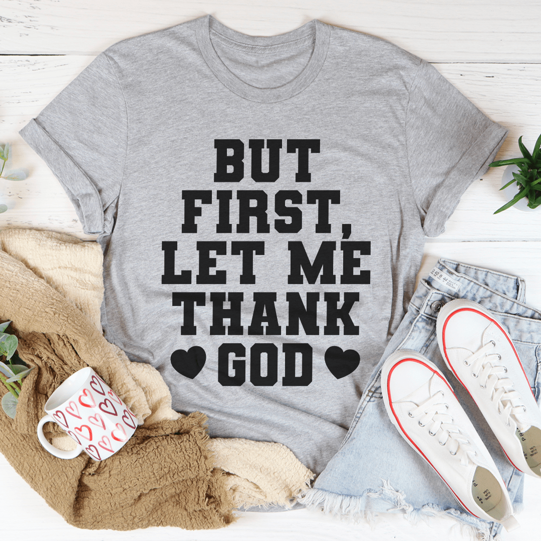 Gray T-shirt with "BUT FIRST, LET ME THANK GOD" text and heart icons.