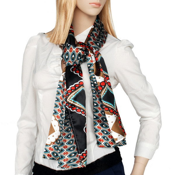 Silk scarf worn at neck, black with red and teal ornamental shapes