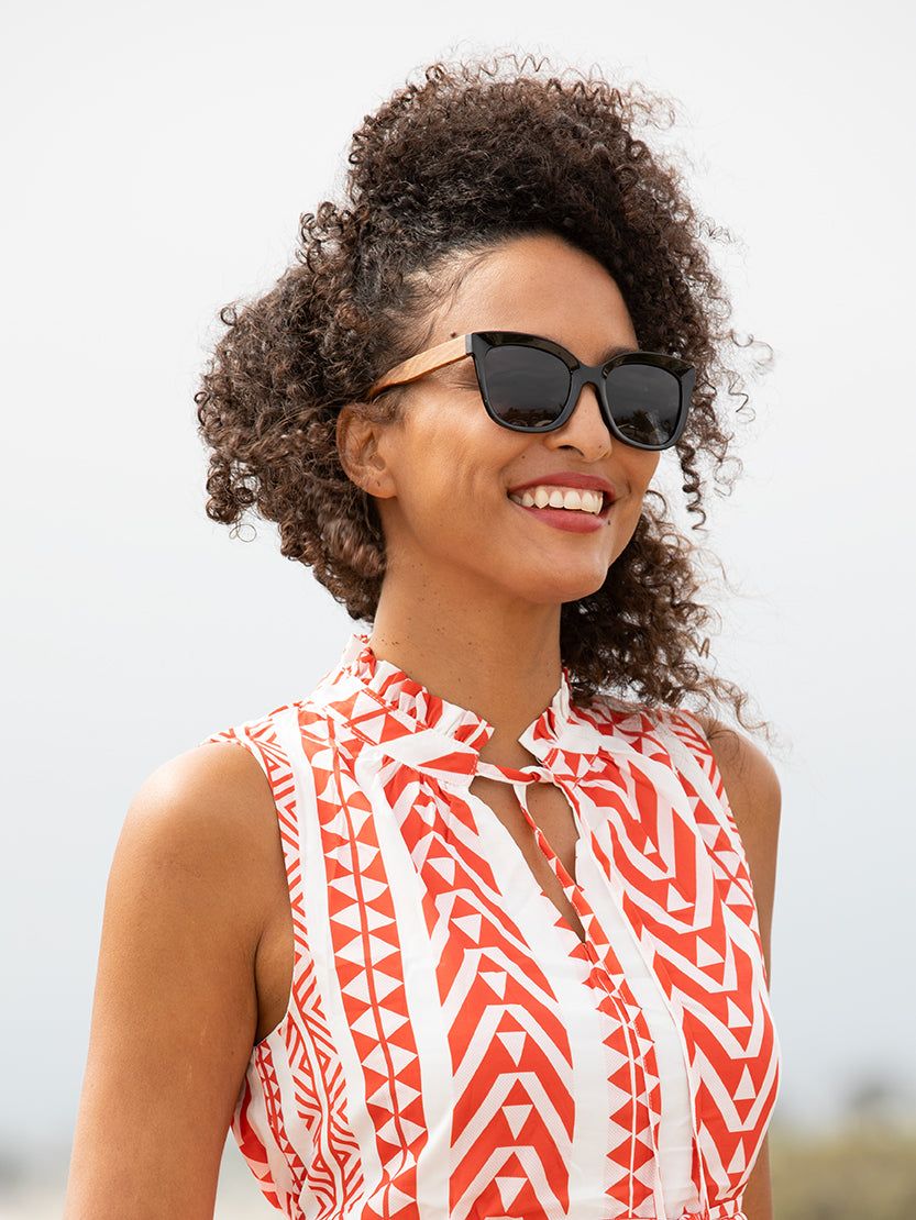 NORA polarized sunglasses with black frames and dark tinted lenses on face