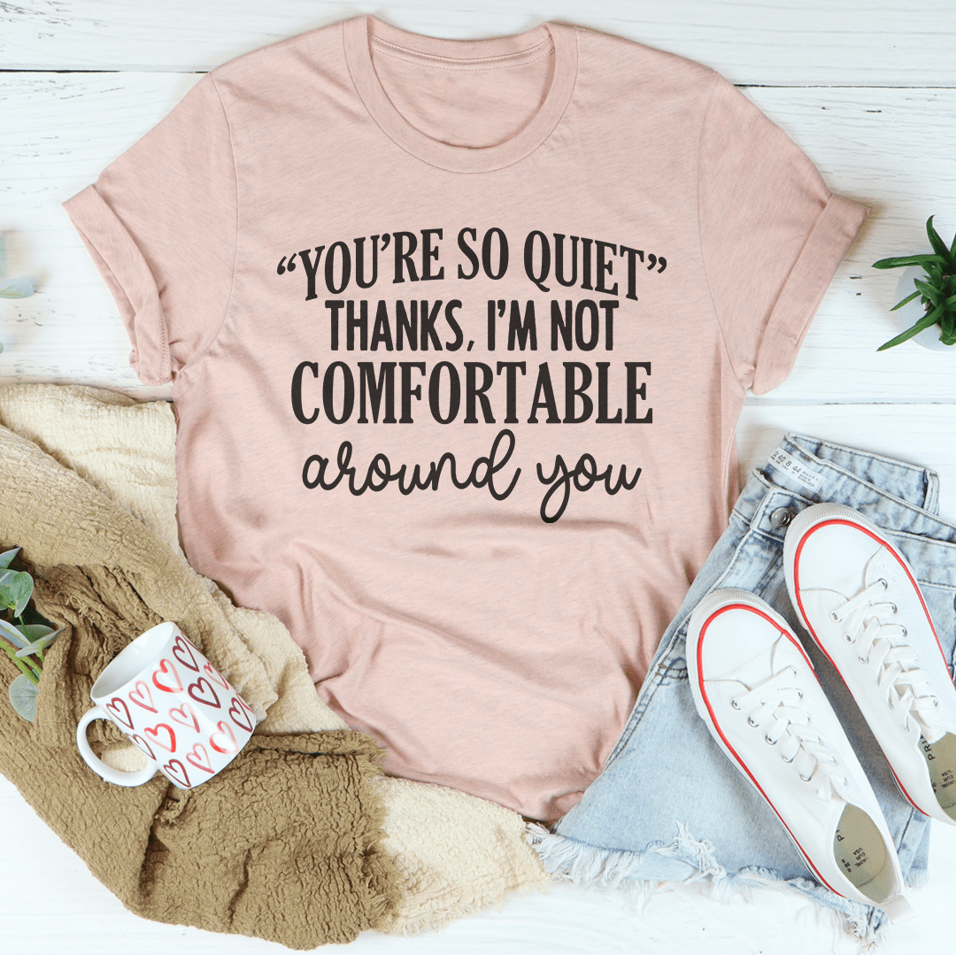 Light pink graphic T-shirt with front quote “YOU’RE SO QUIET” and “NOT COMFORTABLE”